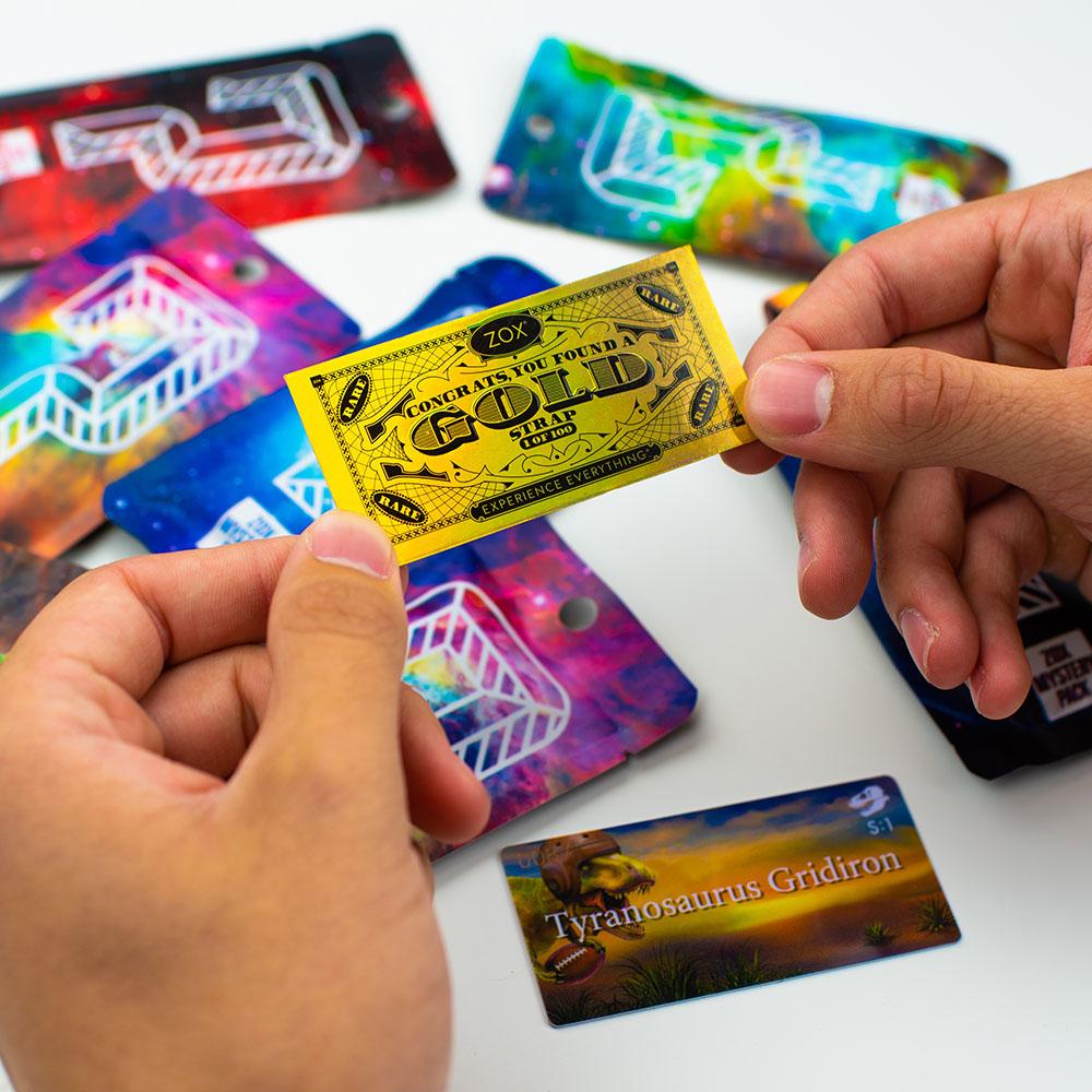 Hands holding a golden ticket with mystery strap packages on the table