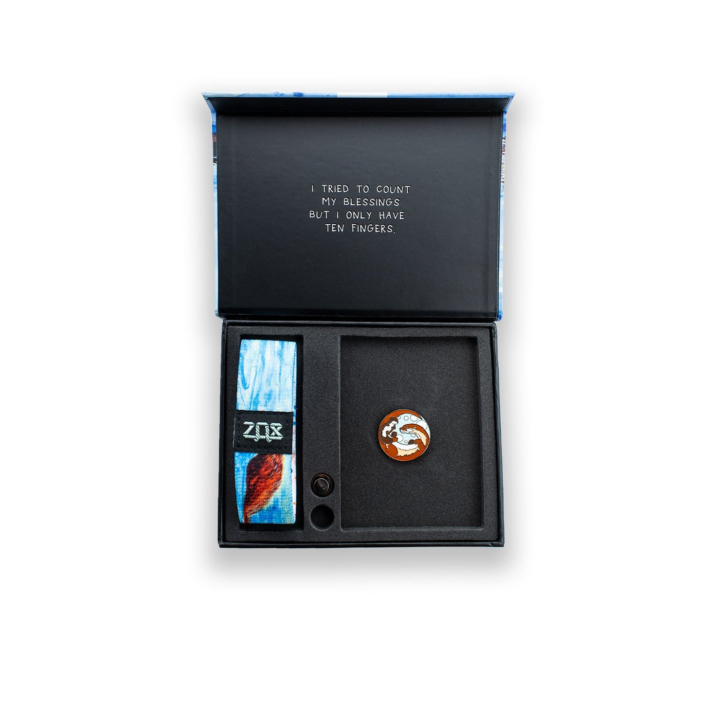 Outside is blue and white water with a brown otter floating down the river. Comes with a matching collector's box and an otter lapel pin.