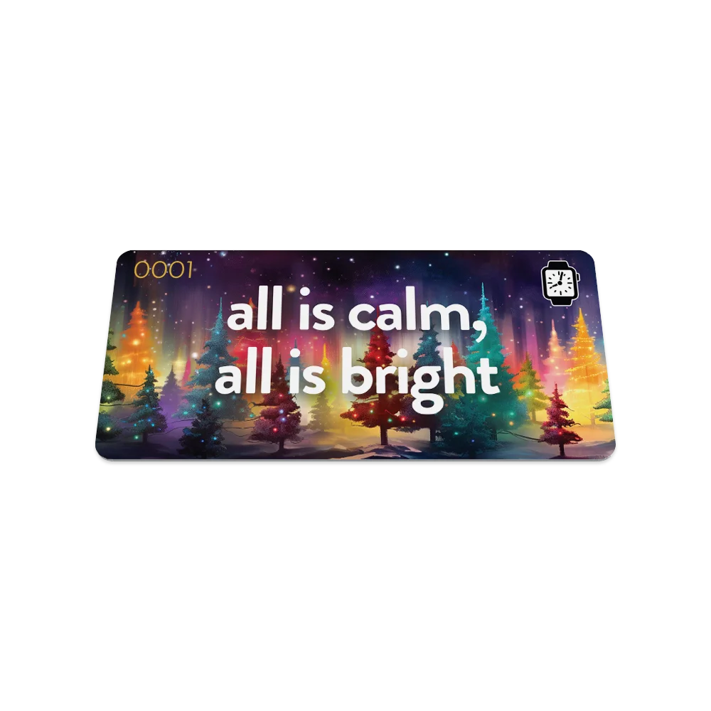 Product photo of the front of the collector’s card for All is Calm, All is Bright. The design features a vibrant night-time scene with a forest of evergreen trees illuminated by glowing lights in red, green, and yellow. The text 'all is calm, all is bright' is prominently displayed in bold white letters across the center, set against a dark, starry sky.