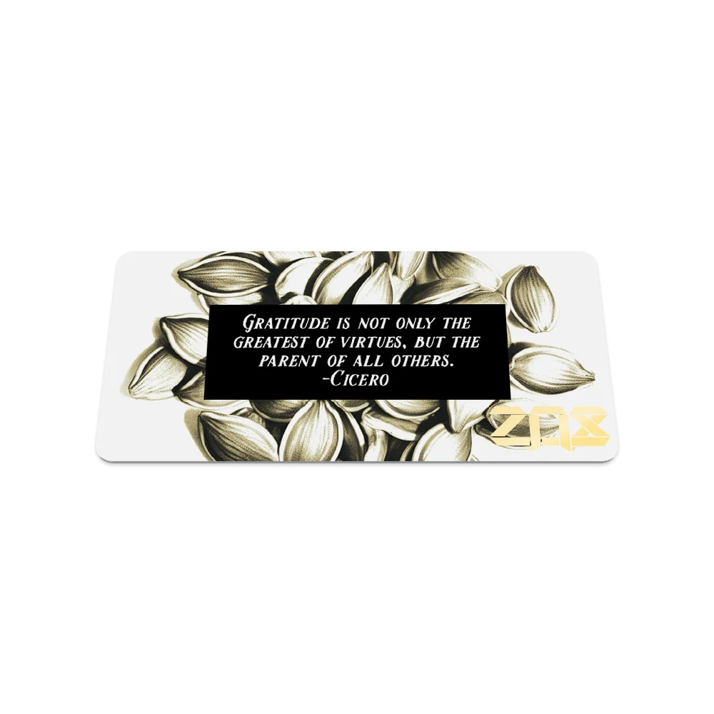 Product photo of the back of the collector’s card for Always Grateful. The back design is white with neutral toned flower petals. There is poetic message in white text with a black rectangular background: "Gratitude is not only the greatest of virtues, but the parent of all others. -Cicero" The ZOX logo is printed in gold in the bottom right corner.