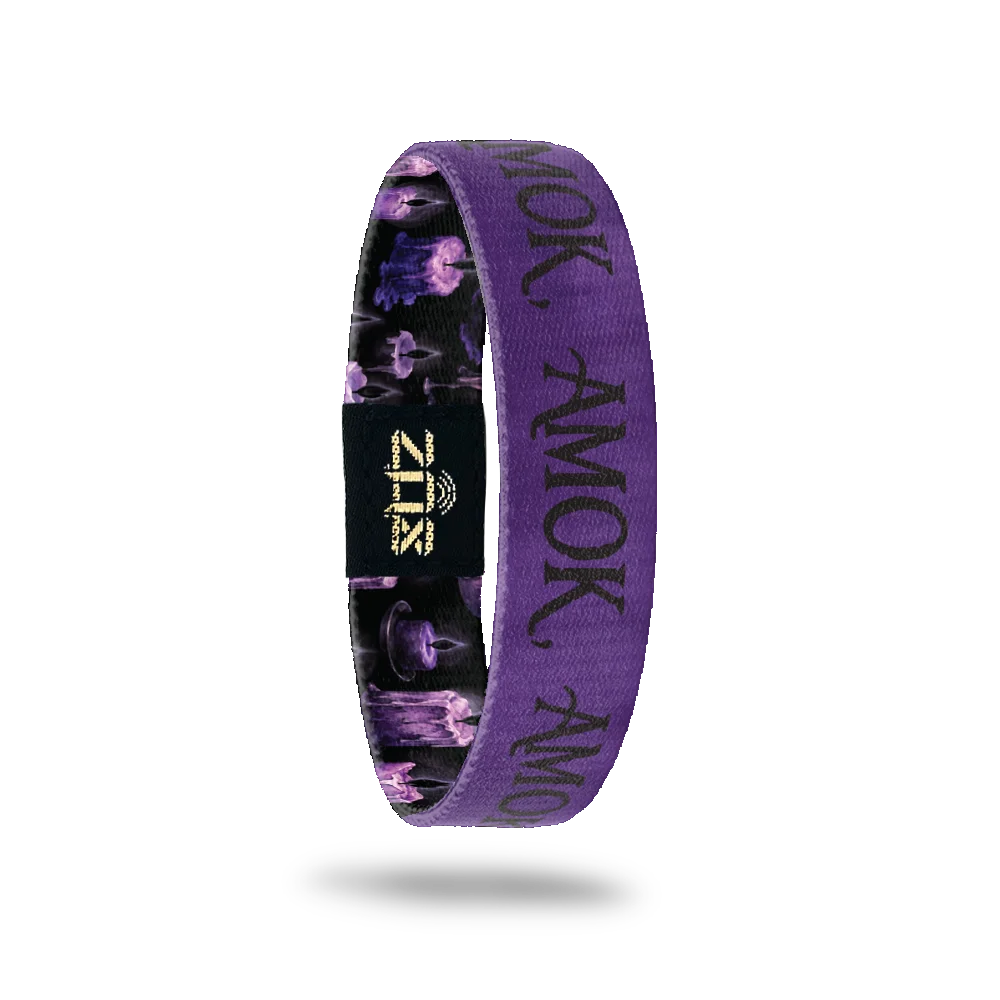 Inside of the AMOK bracelet, with the word AMOK repeating across the candle print