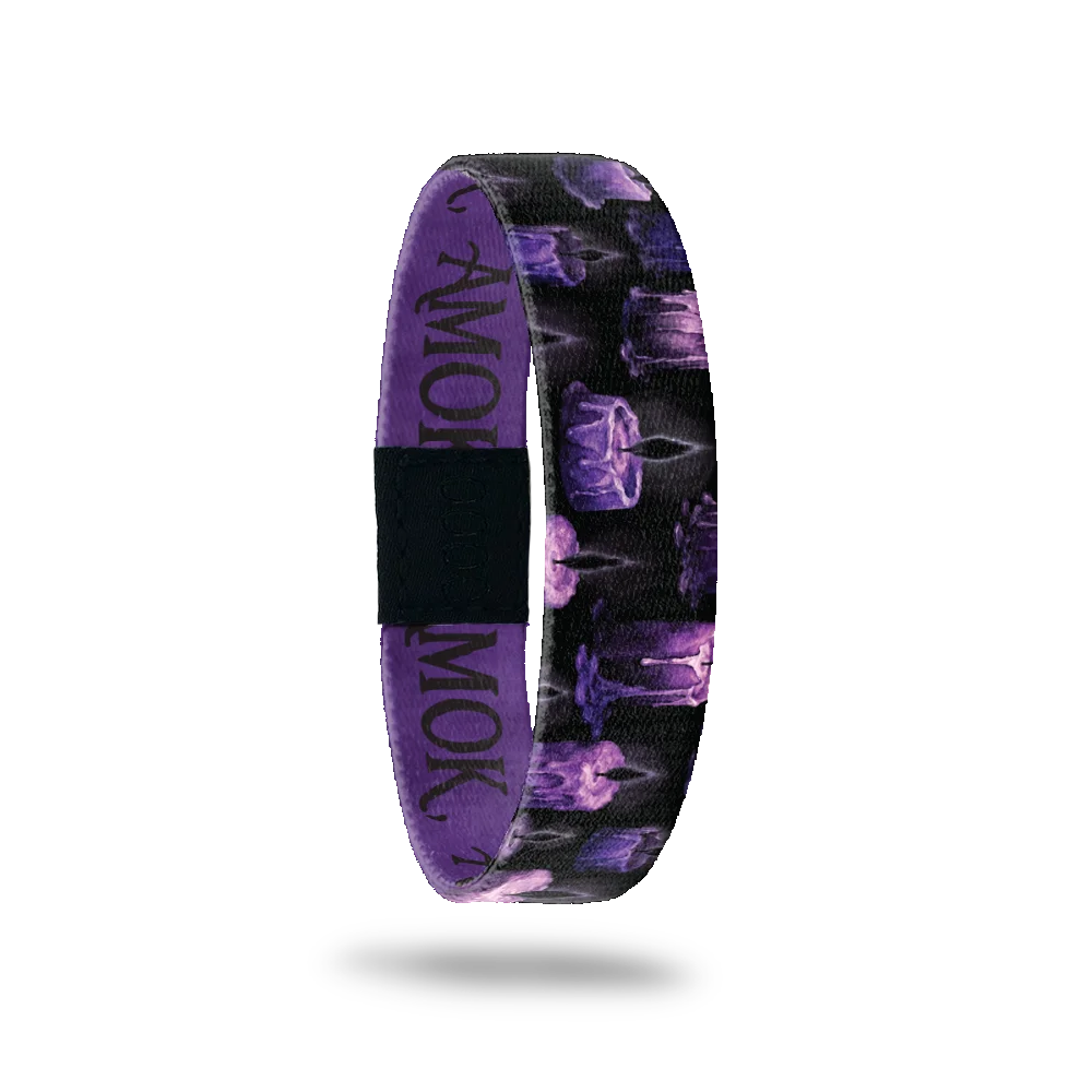 AMOK bracelet showing purple and black candles with dripping wax on a dark background