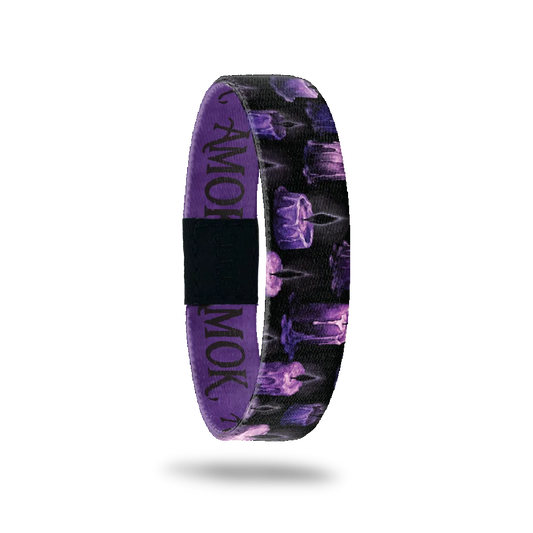 AMOK bracelet showing purple and black candles with dripping wax on a dark background