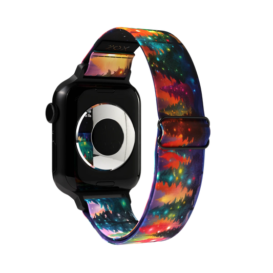 Product photo of the outside of the All is Bright, All is Calm watch band. The design features a colorful, night-time landscape with a forest of evergreen trees lit up by soft, glowing lights in hues of red, green, and yellow.