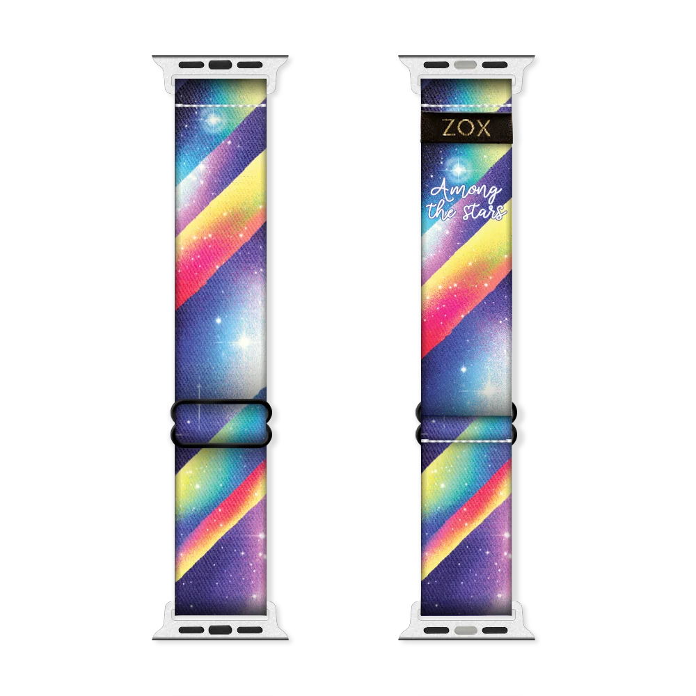 Apple Watchband render of the "Among the Stars" design, showing both the outside (left) and inside (right) of the band. The outer side on the left features a colorful, galaxy-inspired pattern with diagonal stripes of purple, pink, yellow, and blue, along with white stars scattered across the cosmic background. The inside on the right mirrors this design, with the addition of the phrase "Among the Stars" in white script near the top, and the "ZOX" logo in gold on a black background. 