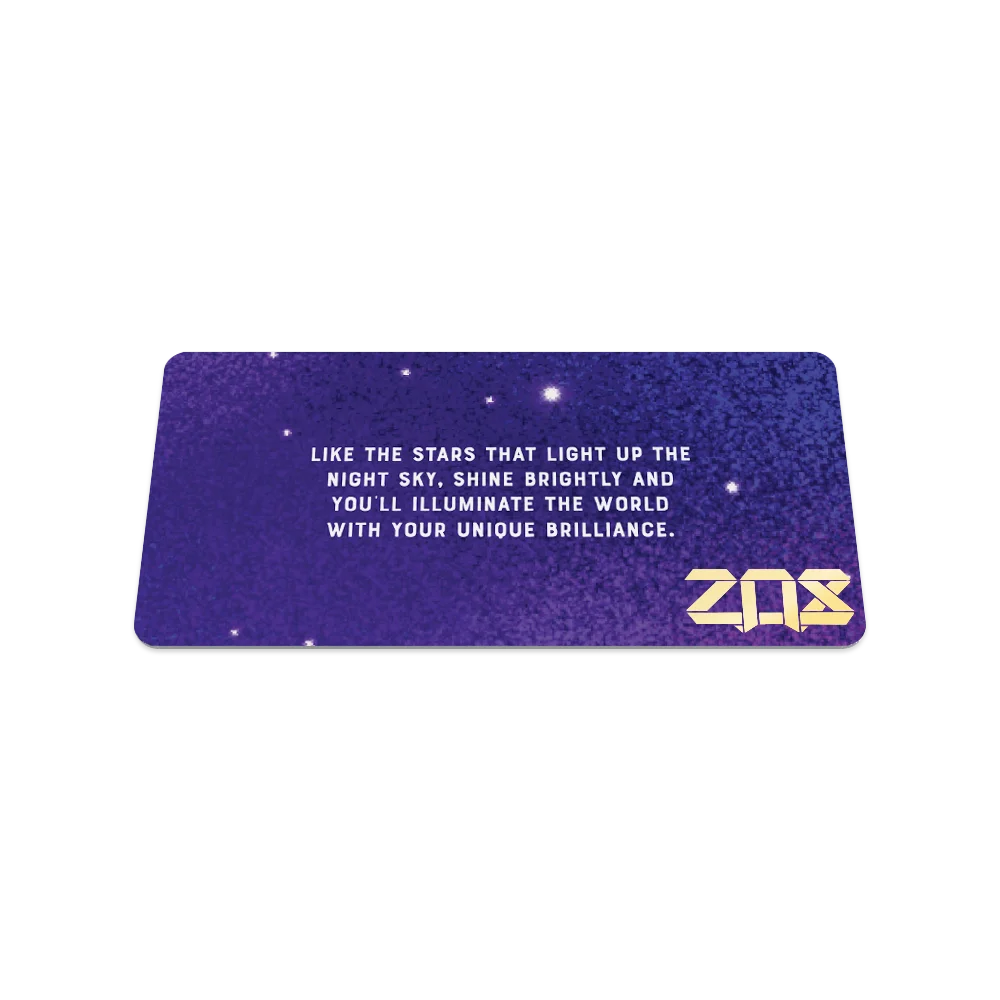 Product photo of the back of the collector’s card for Among the Stars.The back design is a blend of purple shades with a few white stars. There is poetic message in white text: "Like the stars that light up the night sky, shine brightly and  you'll illuminate the world with your unique brilliance." The ZOX logo is printed in gold in the bottom right corner.