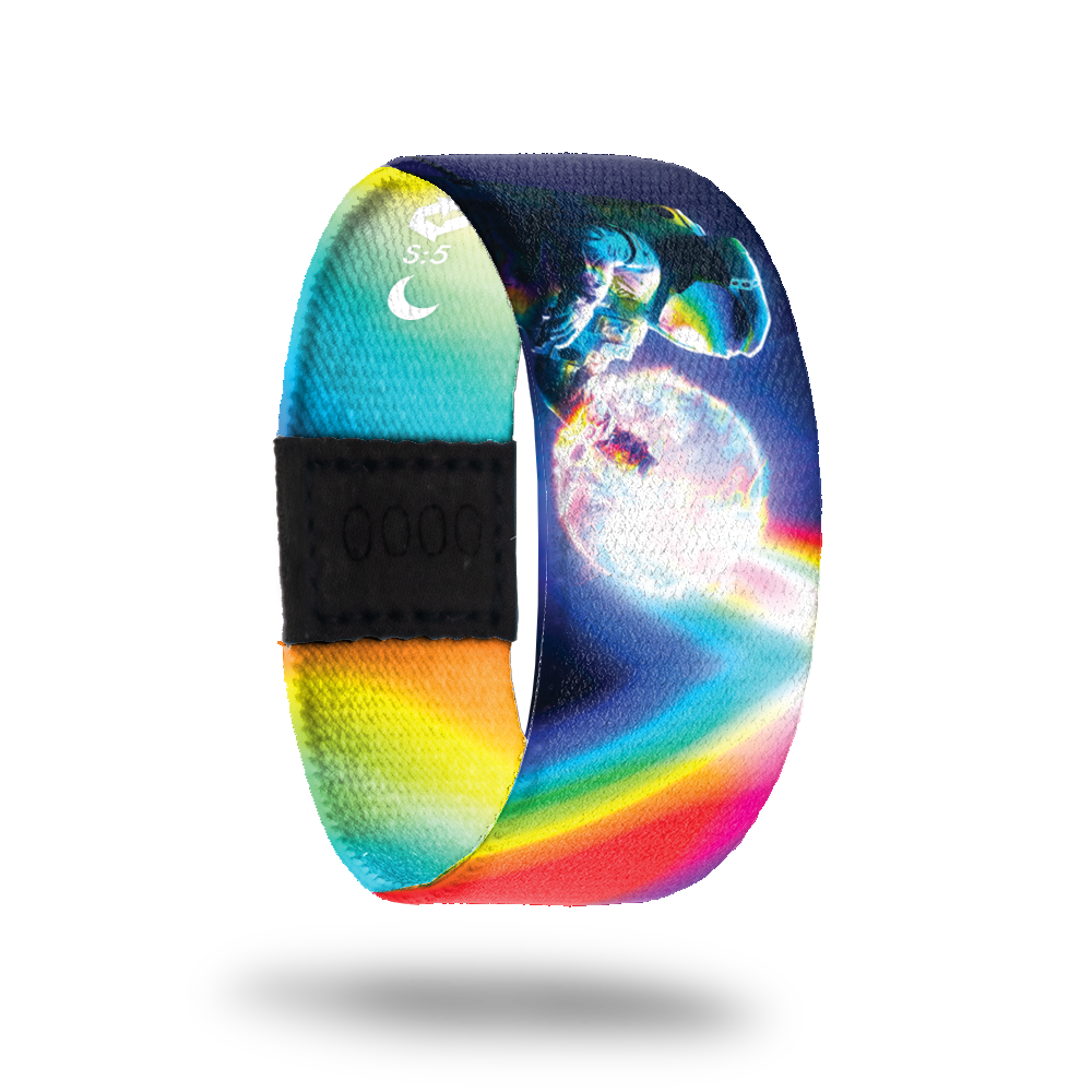 An astronaut floating in space with a glowing sun behind him. Rainbow prism rays all over entire band and reflecting off the astronaut's helmet. Inside is rainbow prisms and says Be A Light. This is a reward item and not purchasable.  