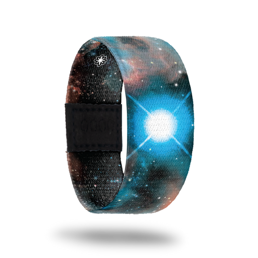 This is a reward strap and not purchasable. You can earn this reward by collecting and redeeming 5 white tickets/stars. The band is reversible. On the outside, there is a blue, brown and black nebula design with a large white star in the middle. The inside is similar in color and says Beacon Of Light.