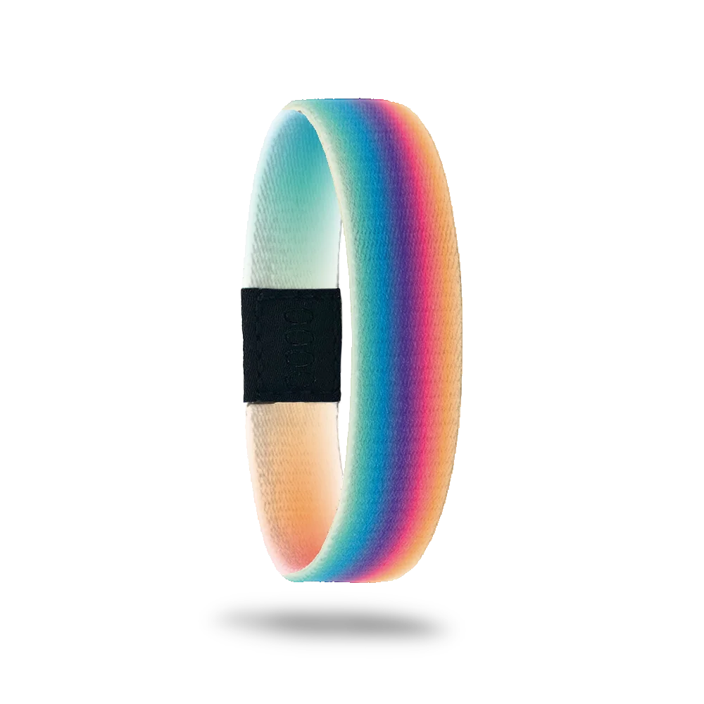 This is a reversible wristband. The design is a gradient rainbow that is blurred so the colors are more muted than primary colors. The inside is yellow and green gradient with the words Believe In Miracles. 