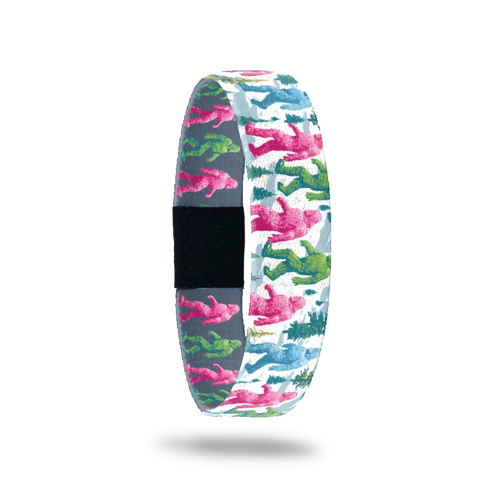 Best Foot Forward bracelet showing bigfoots in pink, green and blue walking across a snowy scene