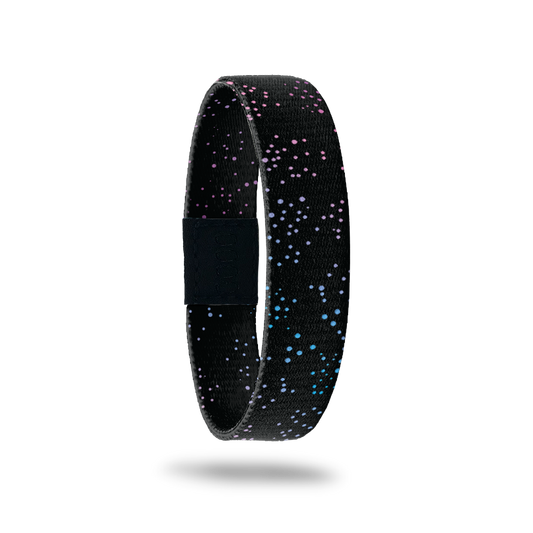 This is a reversible wristband. The design is black with gradient colored small dots all over. The inside is the same and says Collect The Happy Moments.