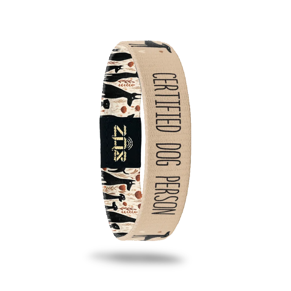 Inside of the Certified Dog Person bracelet, with the words Certified Dog Person across the dog and floral print
