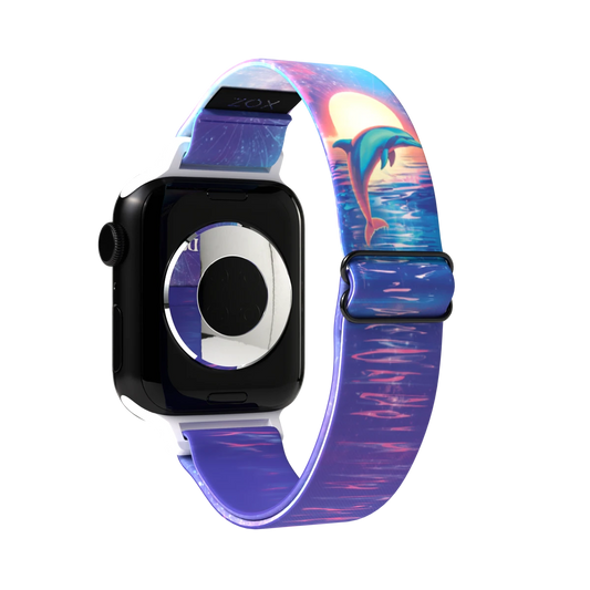 Watchband render showing the outside of the band. The outer side displays a vivid image of a dolphin leaping out of the water with a sunset in the background, set against a gradient of blue and purple hues, with reflective water patterns.