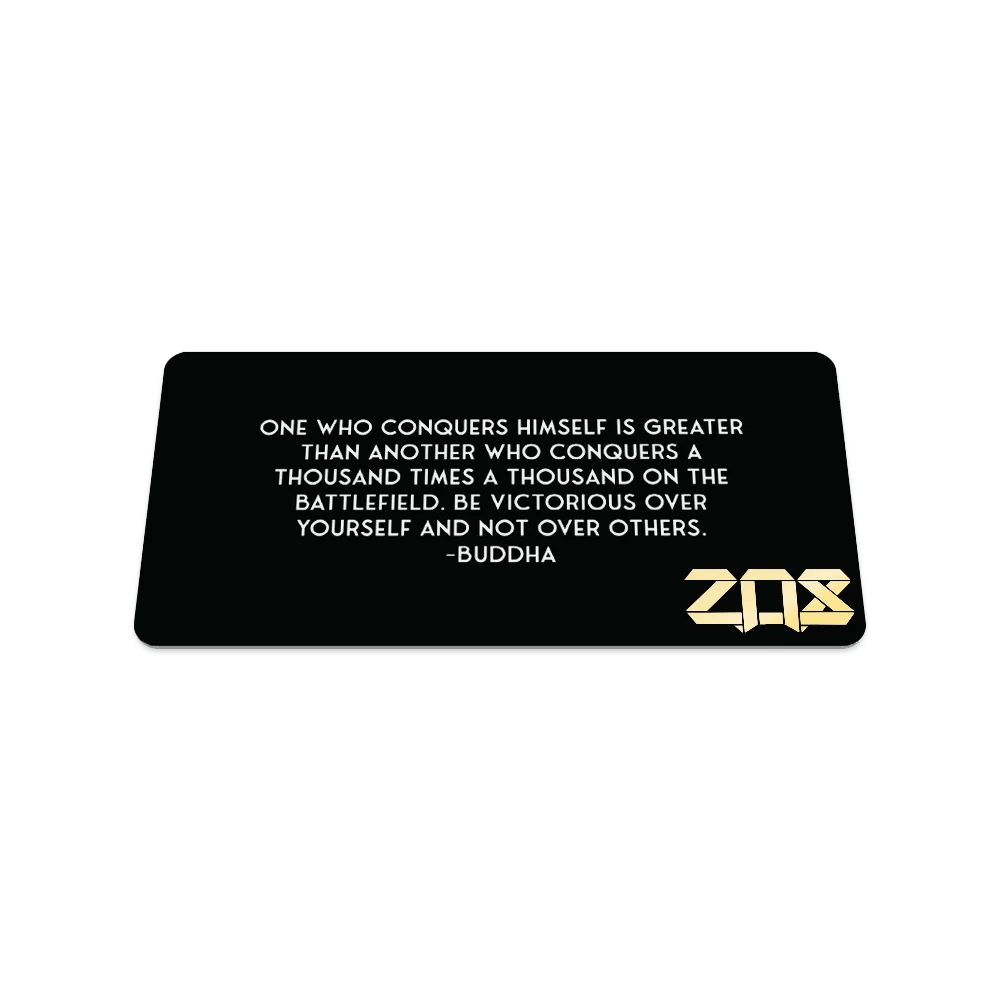 Product photo of the back of the collector’s card for Focus Inward. The design is solid black with a quote from Buddha in white text: "One who conquers himself is greater than another who conquers a thousand times a thousand on the battlefield. Be victorious over yourself and not over others." The ZOX logo is printed in gold in the bottom right corner.