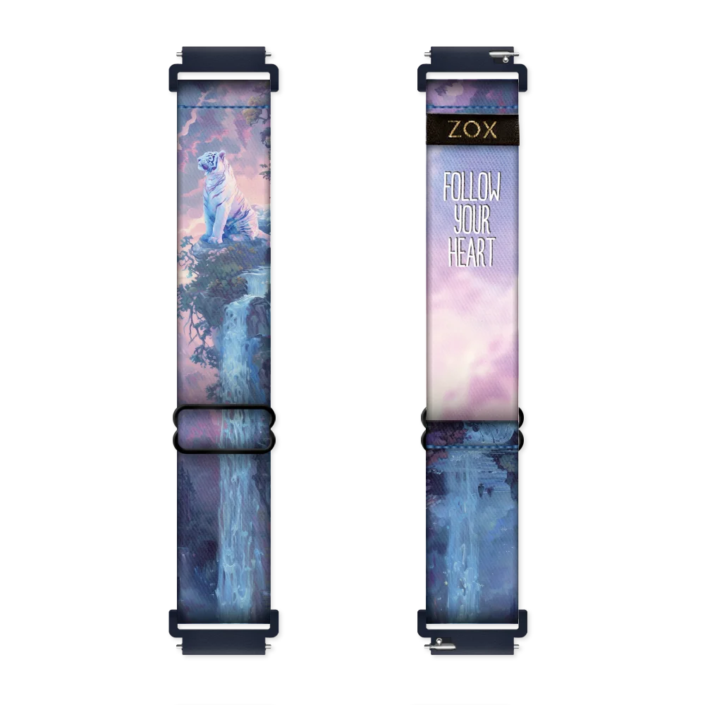 This is a watchband. The outside design is purple, pink and blue colors and is a Tiger sitting on top of a cliff surrounds by wooded areas and a waterfall. The inside reads Follow your heart.