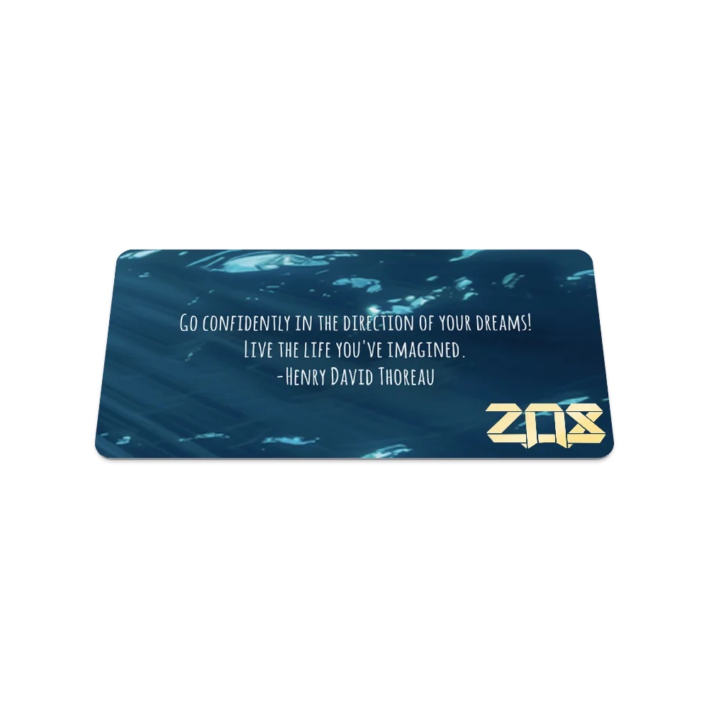 Product photo of the back of the Free Spirit collector's card, displaying a deep blue underwater background with soft light filtering through the water. White text in the center reads, "Go confidently in the direction of your dreams! Live the life you've imagined. – Henry David Thoreau." The gold "ZOX" logo is in the lower right corner.