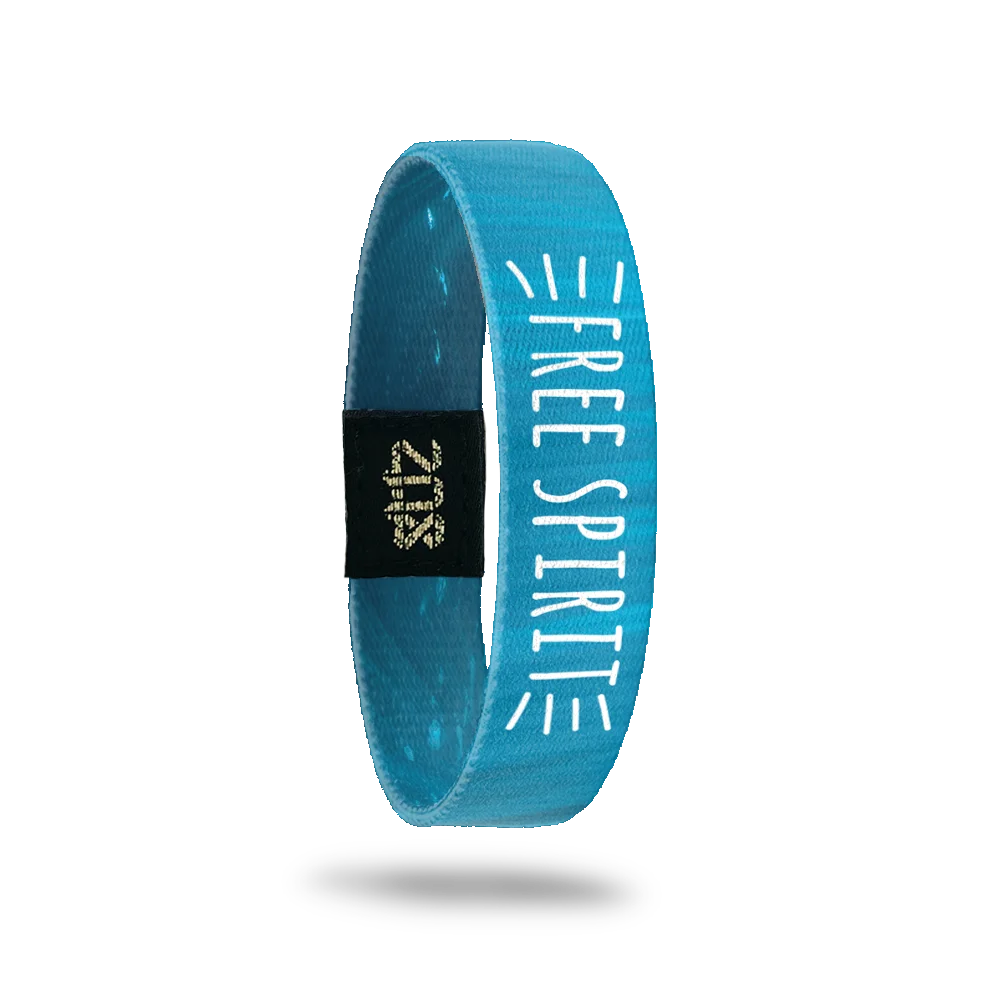 Product photo of the inside of the Free Spirit bracelet, continuing the blue underwater theme. Bold white text reads "FREE SPIRIT" vertically along the strap, with small lines radiating outward. A black patch with a gold "ZOX" logo is also visible.