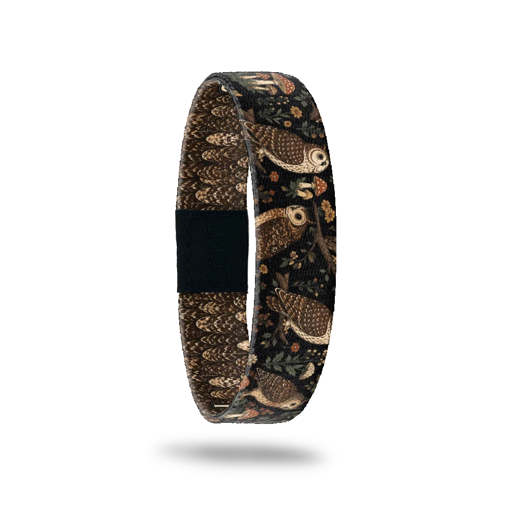 Fresh Out Of Hoots bracelet showing owls perched among ferns, mushrooms and small flowers in a dark wood