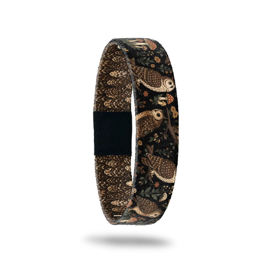 Fresh Out Of Hoots bracelet showing owls perched among ferns, mushrooms and small flowers in a dark wood