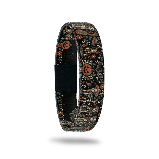 Friends Furever bracelet showing ornate skeleton dogs among pumpkins, flowers and bats on a dark ground