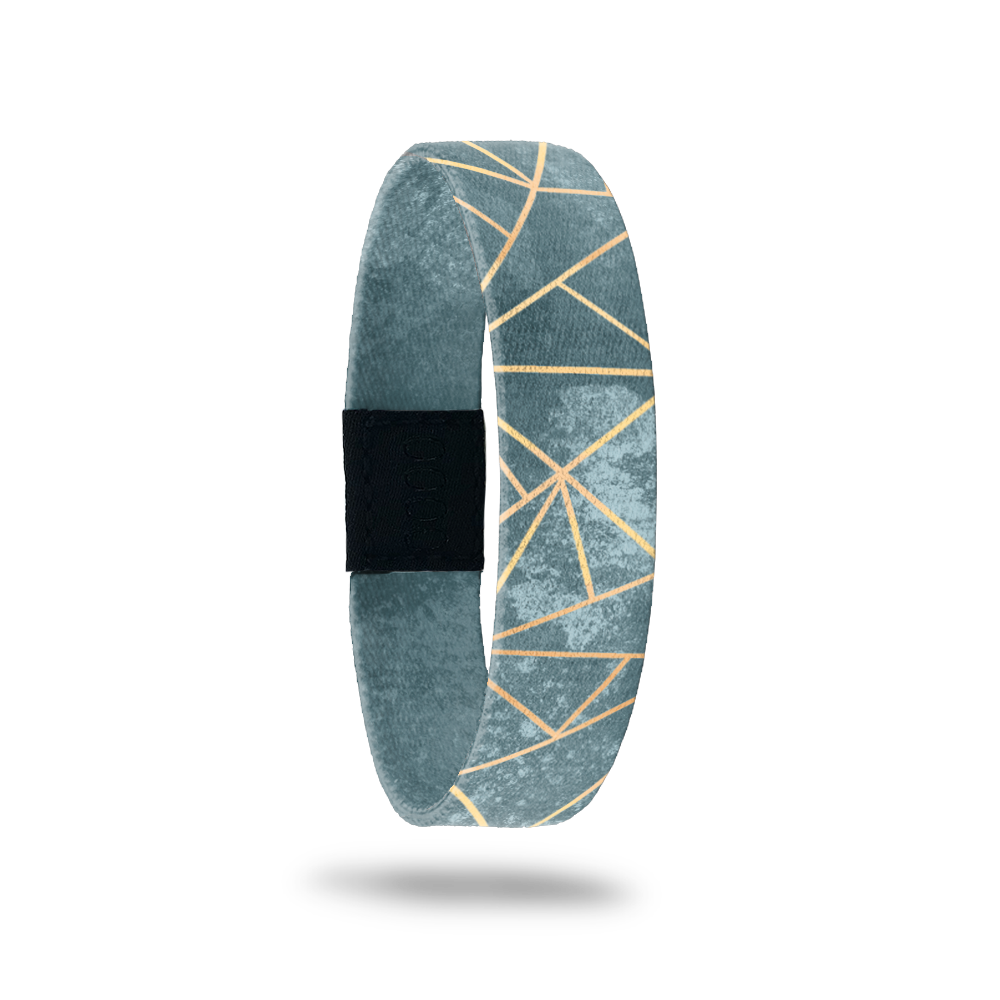 Wristband with muted green/teal marbled look and gold lines in a geometric pattern. Inside reads Greater Things To Come. 