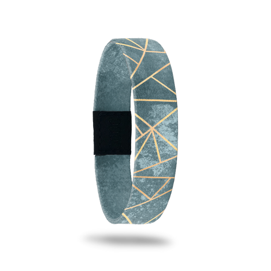 Wristband with muted green/teal marbled look and gold lines in a geometric pattern. Inside reads Greater Things To Come. 