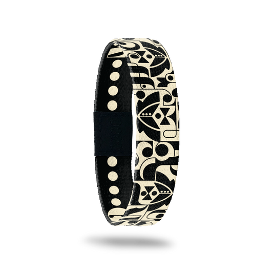 Wristband single with black base and geometric shapes that form tuxes, bowties and dress shirts. Inside reads Groom Crew. 