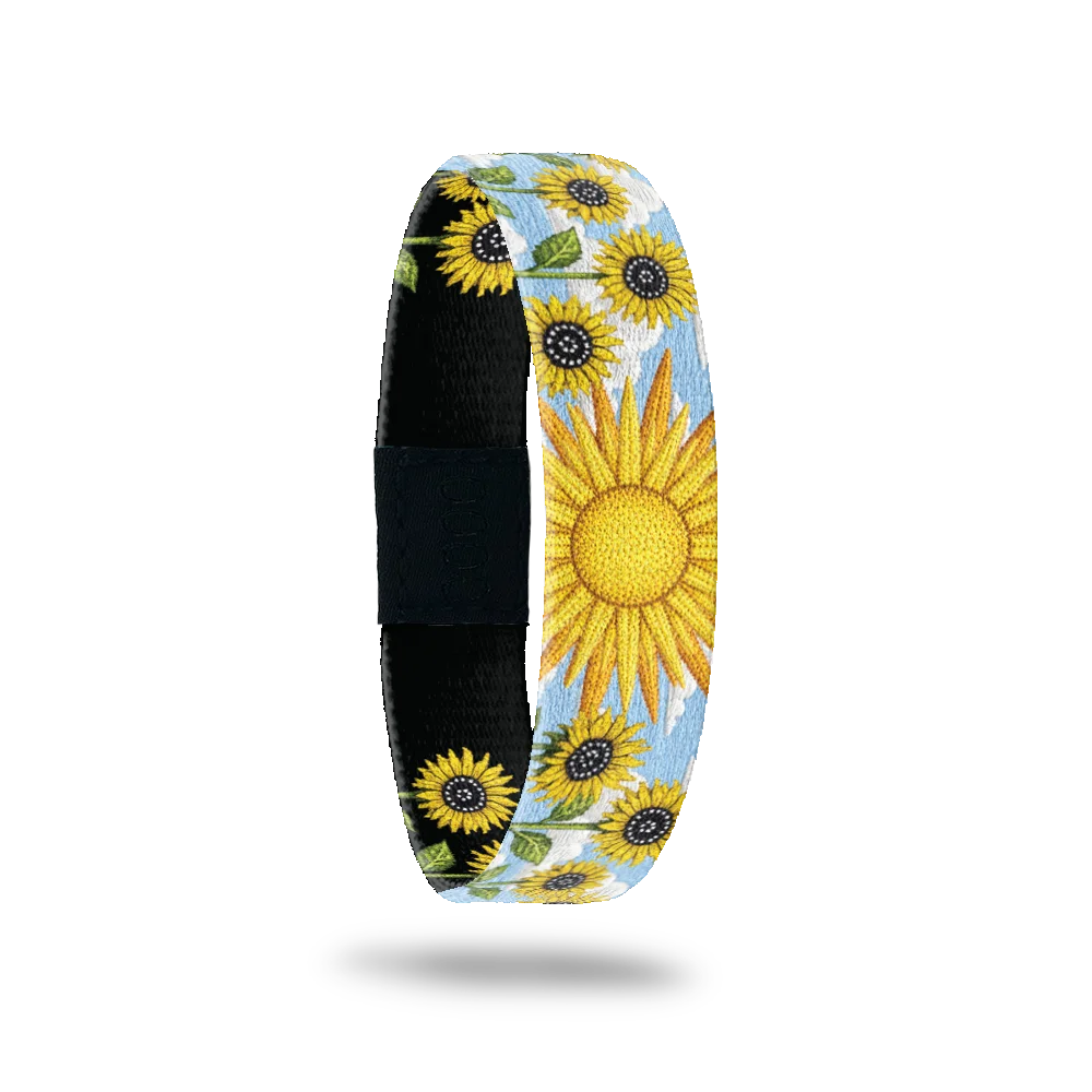 Hello Sunshine bracelet showing a large open sunflower and more sunflowers against a blue sky