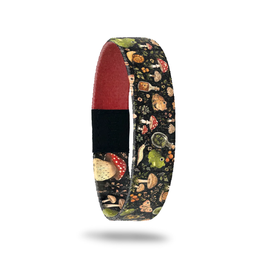 I Live Here Actually bracelet showing mushrooms, frogs, snails and small bottles on a dark woodland ground