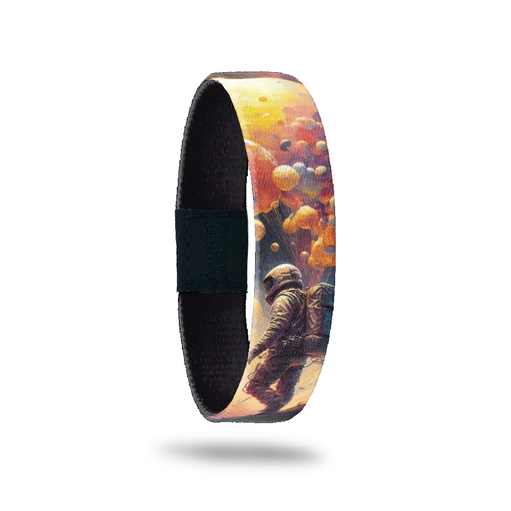 Wristband single is a realistic design of an astronaut walking with bubbles and clouds. The inside is solid black and says It Was All A Dream.