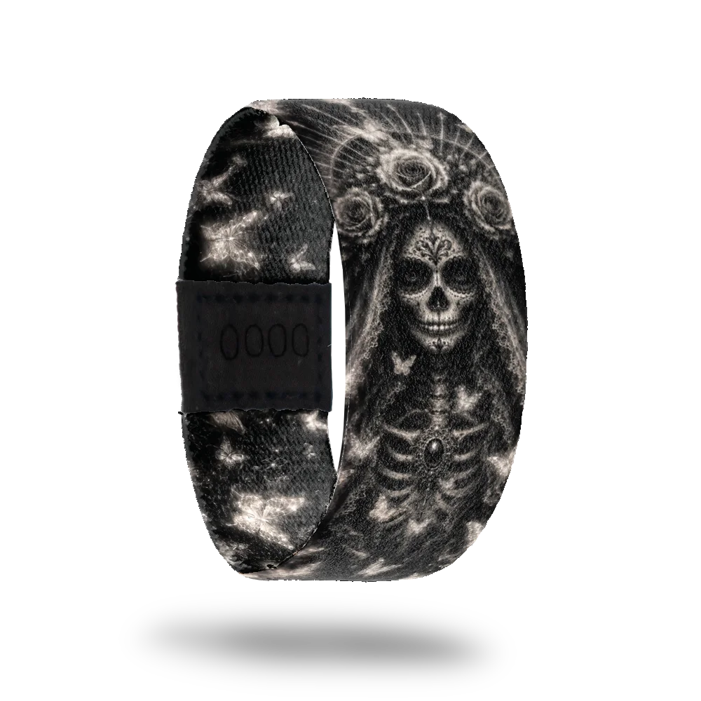 Love Never Dies bracelet showing intricate silver sugar skull and butterfly artwork on deep black
