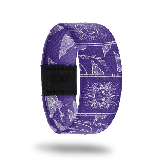 Wristband strap that is purple all over and has white outlines of moons, sodiac images, clouds, vines and suns. The inside is the same and says Make It Count.