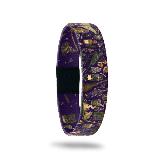 Magic In My Hands bracelet showing potion bottles, spell books, a raven and a broom on deep purple