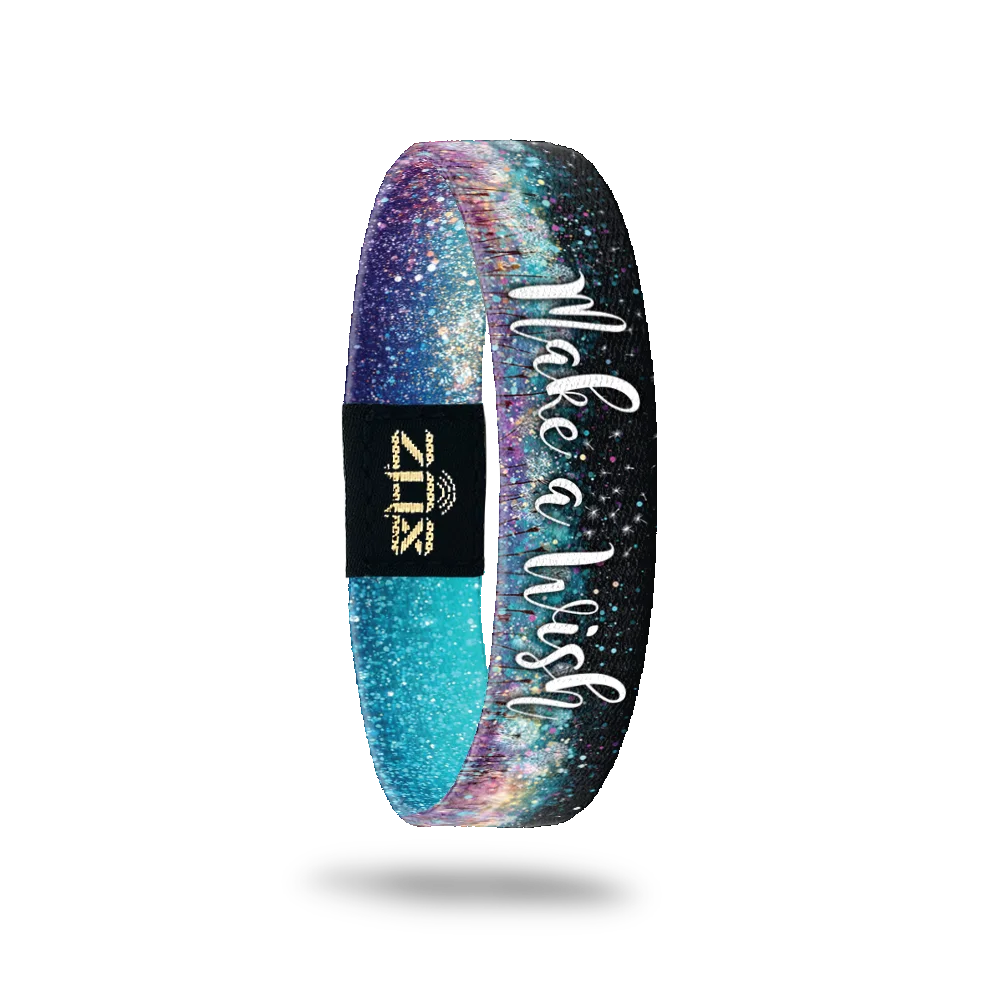 Inside is black on one edge with teal and colorful flower dust on the other edge. Says Make a Wish