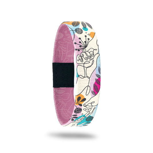 Wristband single with an abstract line drawing of two people holding hands. There are abstract flowers and shapes all over with colors of pink, gold, blue and purple. The inside is the same design in a monochromatic dusty pink and reads My Hand In Yours. 