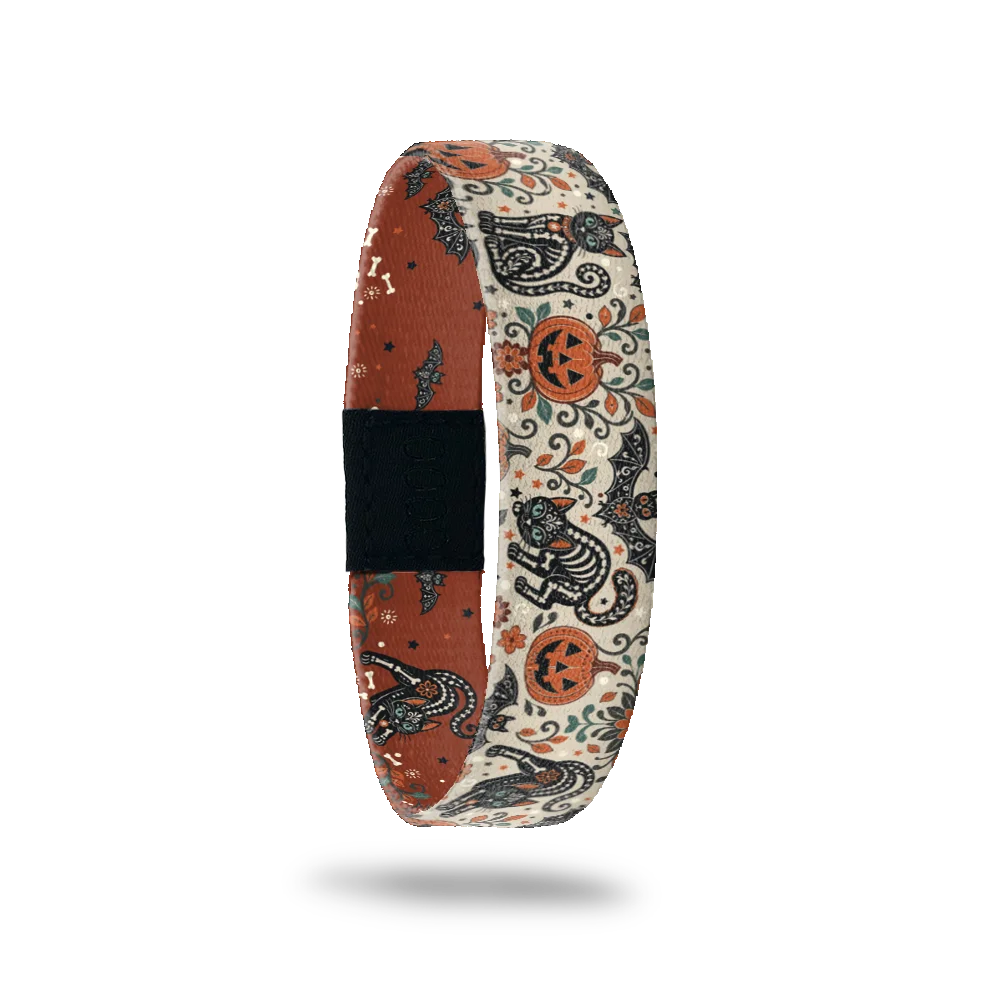 My Whole Heart bracelet showing ornate skeleton cats among pumpkins, bats and flowers on a cream ground