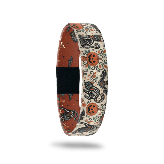 My Whole Heart bracelet showing ornate skeleton cats among pumpkins, bats and flowers on a cream ground