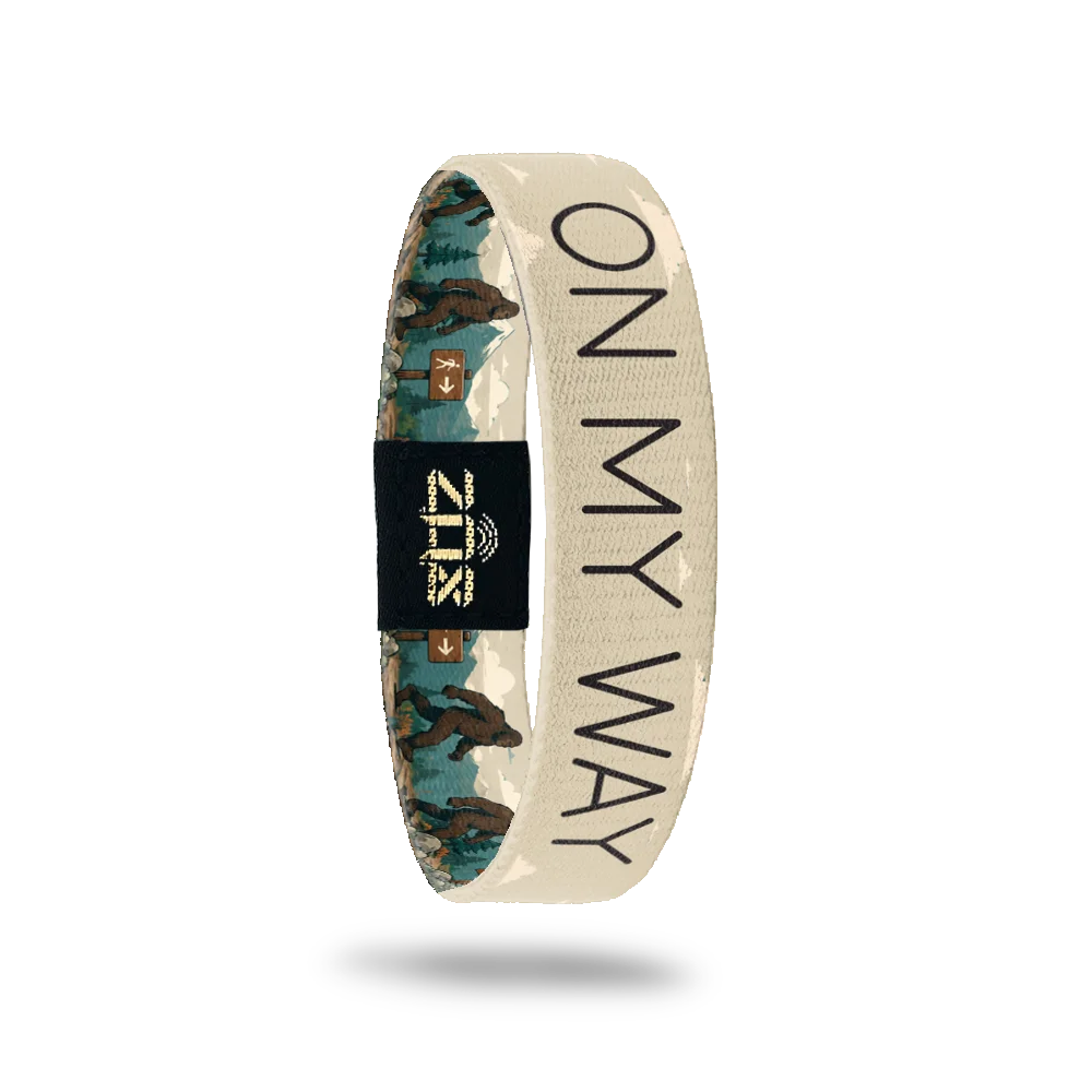 Inside of the On My Way bracelet, with the words On My Way across the mountain trail print