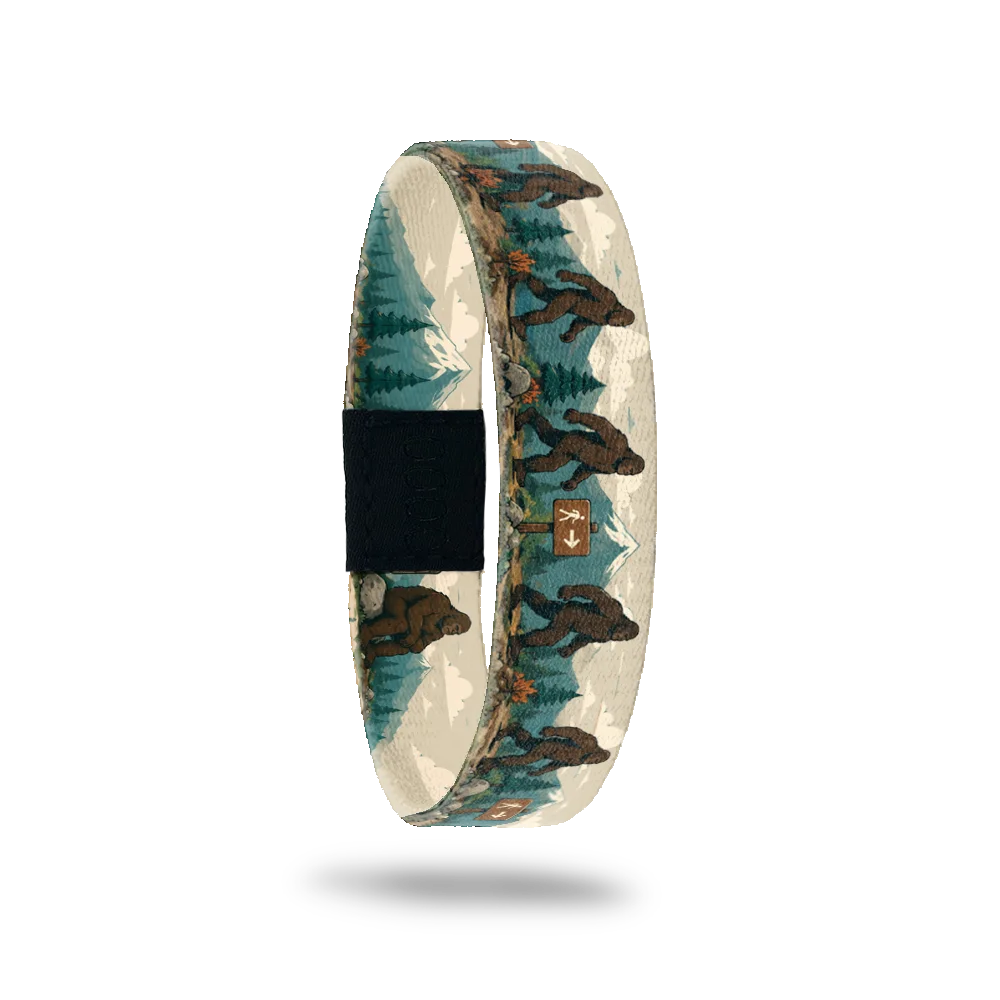 On My Way bracelet showing bigfoots walking past mountains, pine trees and trail signs