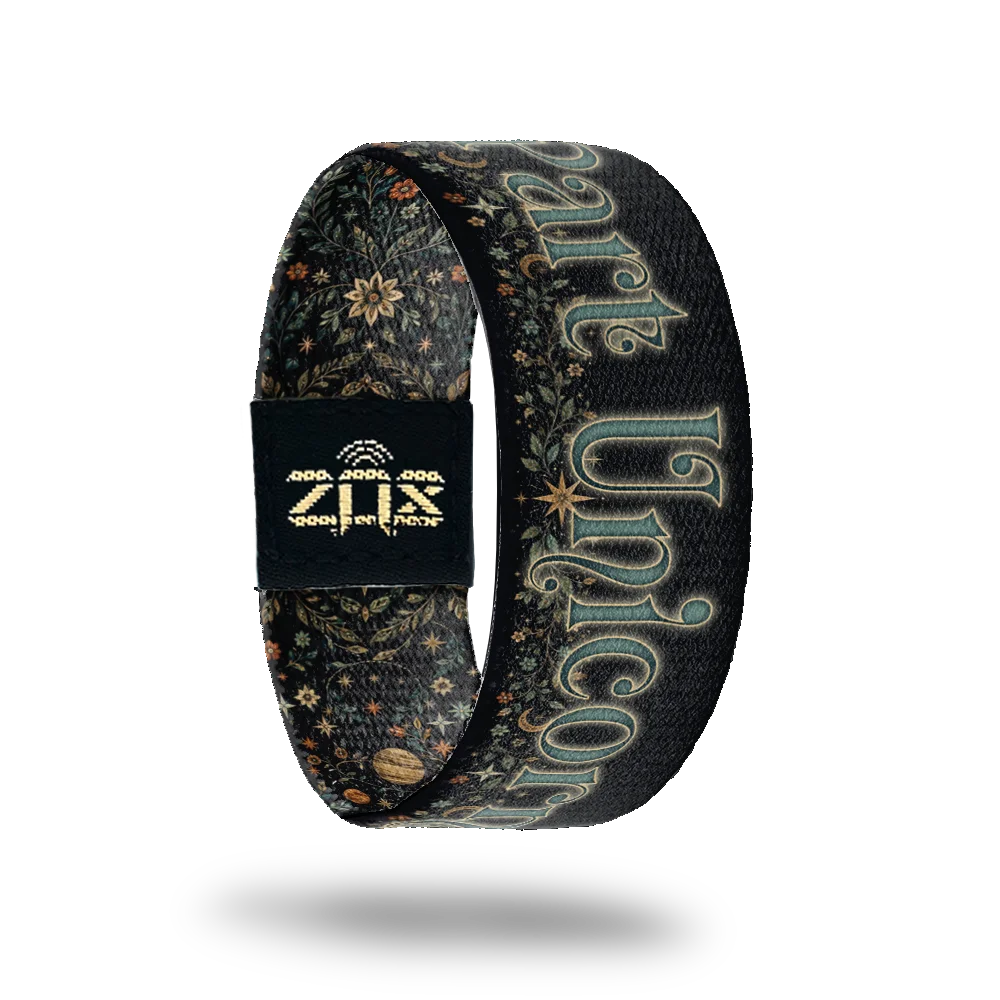 Inside of the Part Unicorn bracelet, with the words Part Unicorn across the narwhal print