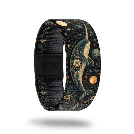 Part Unicorn bracelet showing a narwhal in gold and deep blue among stars, planets and leafwork