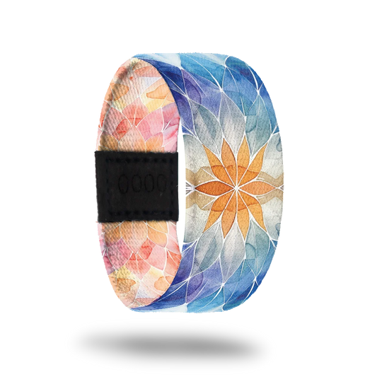 Product photo of the outside of the Perfectly Balanced which features a soft, watercolor-style mandala design. The pattern transitions from warm tones of orange and pink on one side to cool shades of blue on the other.