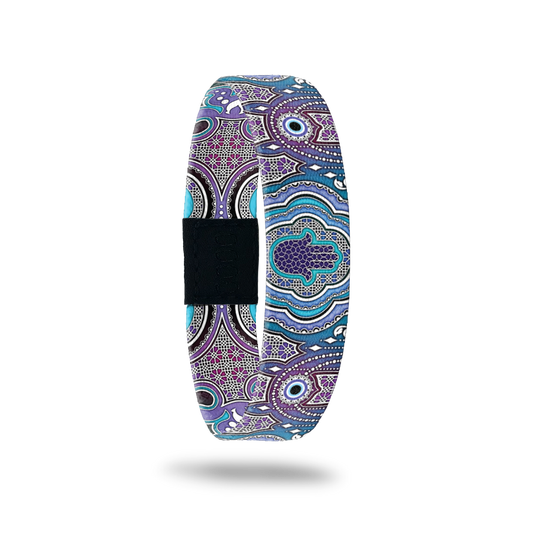 Single with purples and blues in a very detailed mosaic design. The center has a purple Hamsa. The inside is the same and reads Ray Of Light. This comes with a matching Hamsa charm to wear on the band. 