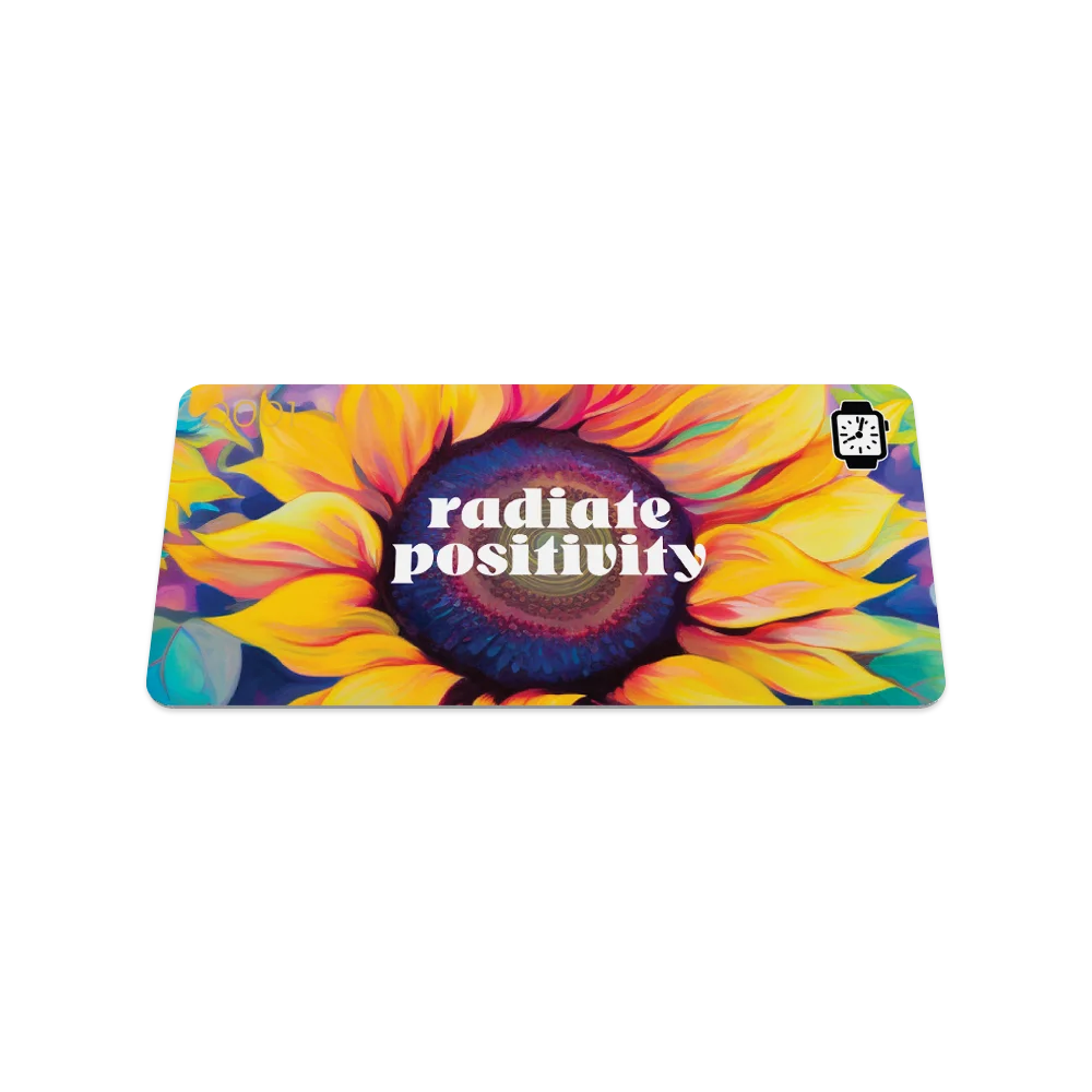 Product photo of the front of the collector’s card for Radiate Positivity. The front design prominently features a large sunflower with vivid yellow petals and a deep blue and purple center. The text 'radiate positivity' is displayed in bold white letters across the center of the sunflower.