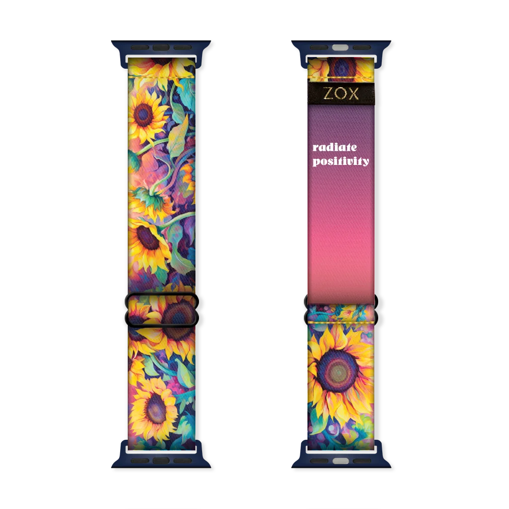 Apple watchband render of the Radiate Positivity design, showing both the outside (left) and inside (right) of the band. The outer side on the left features a vibrant sunflower pattern with bright yellow petals, dark centers, and green leaves against a deep, contrasting background. The inside on the right displays a gradient design transitioning from deep purple at the top to vibrant pink at the bottom, with the phrase 'radiate positivity' printed in bold white text. The ZOX logo is visible near the top.