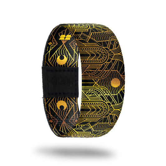 This is a reward, do not purchase. Black strap with gold lines all over in an abstract pattern. The inside is the same and reads Speak Easy. Comes with a matching lapel pin.  