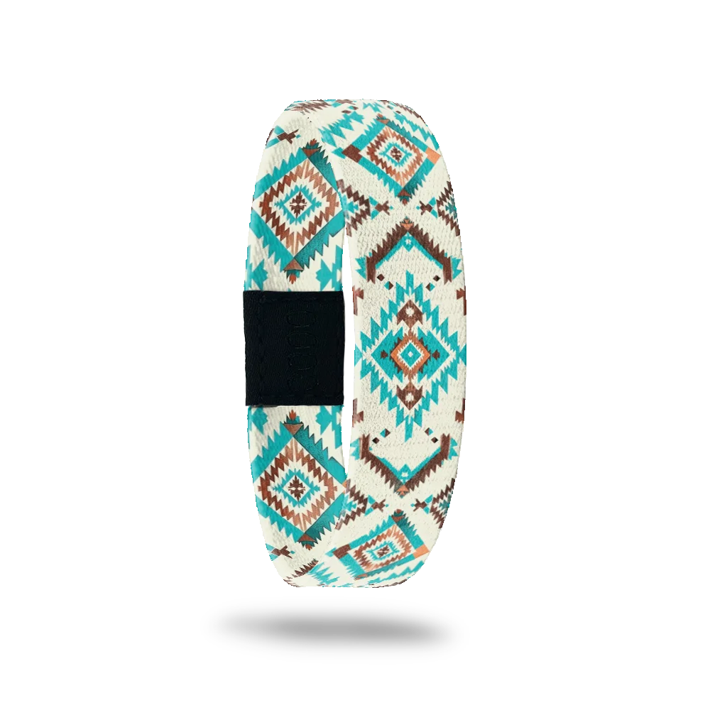 Take The Long Way bracelet showing a southwestern diamond pattern in turquoise and rust on cream