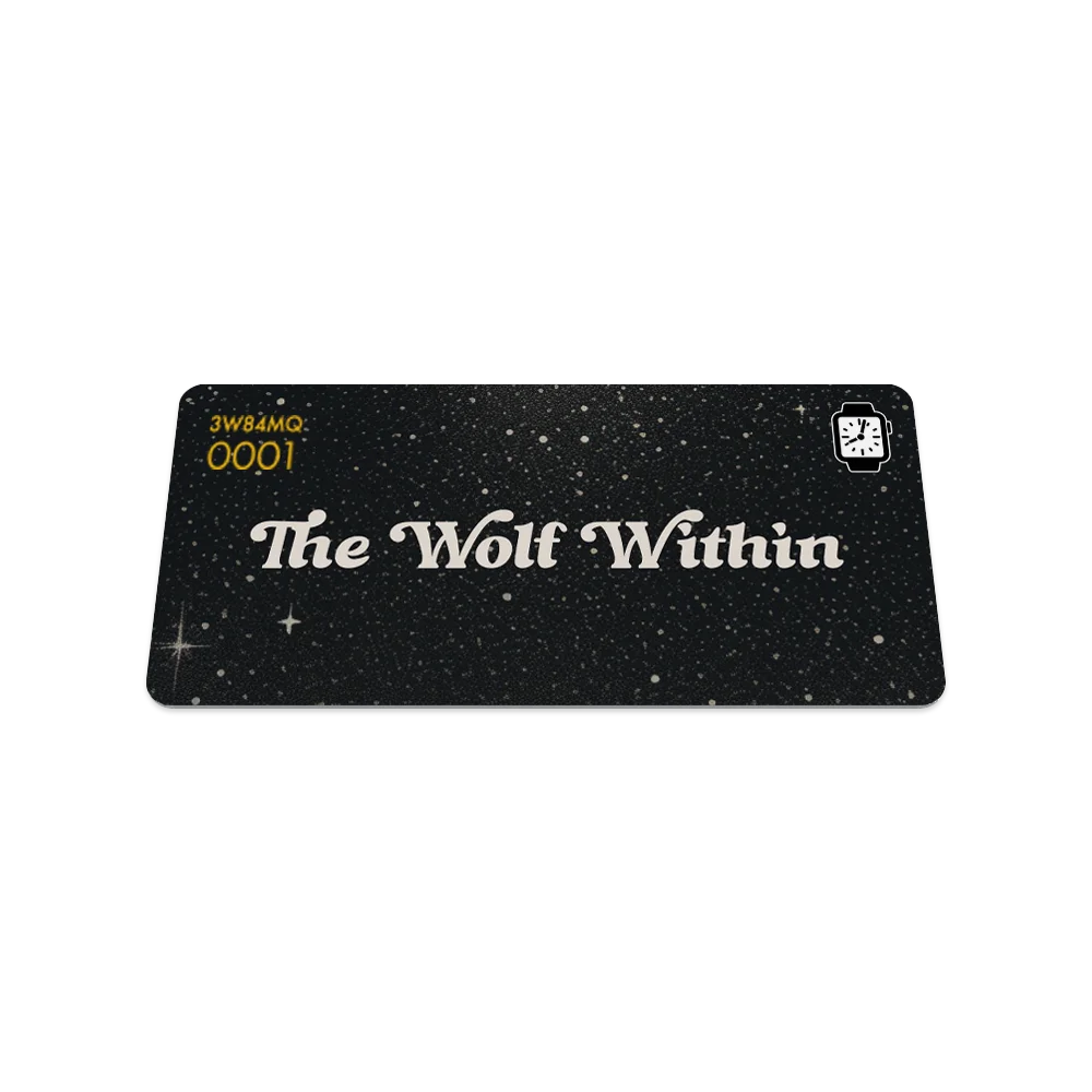 A rectangular card displays a black, starry background with "The Wolf Within" in large white script at the center—symbolizing inner strength. Gold numbers and a small white clock icon decorate the top corners. Product: The Wolf Within Watch Band.