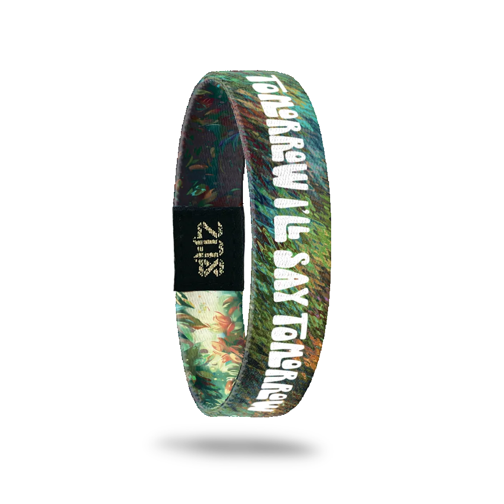 The inner side of the bracelet continues the forest-themed background with rich greenery. Bold white text reads, "Tomorrow I'll say tomorrow." A black patch with a gold "ZOX" logo is also visible.