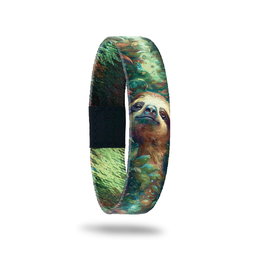 A bracelet featuring a detailed illustration of a content sloth surrounded by lush, green foliage. The design includes shades of green, brown, and blue, creating a serene, natural atmosphere. A black rectangular patch with etched serial numbers is visible on one side of the strap.